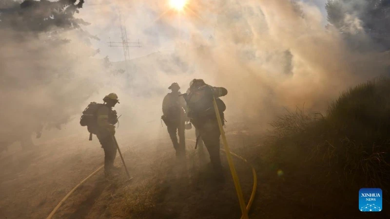 Lính cứu hỏa làm việc tại hiện trường vụ cháy Post Fire ở Gorman, cách Los Angeles, khoảng 100 km về phía bắc. (Ảnh: Tân Hoa xã)