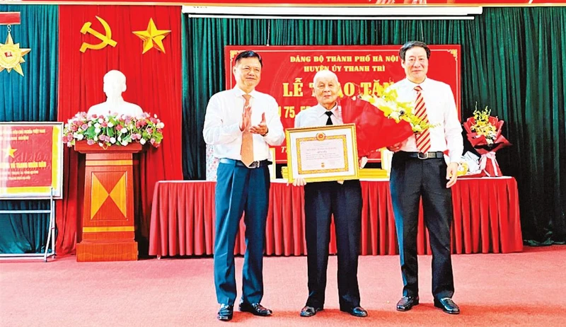 Đảng viên lão thành Lê Tuyến (đảng viên Chi bộ Tổ dân phố số 3, xã Vĩnh Quỳnh, huyện Thanh Trì) nhận Huy hiệu Đảng 75 năm tuổi Đảng vào đúng dịp Quốc khánh 2/9. (Ảnh MAI THOA) 