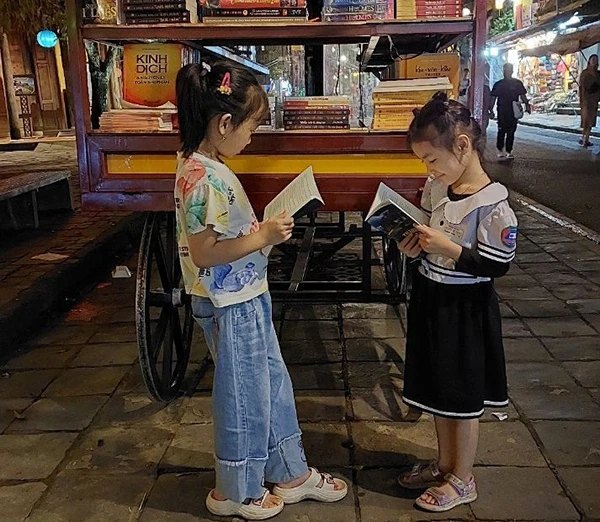 Đường sách phố cổ thu hút cả các bạn đọc nhí ở Hội An. (Ảnh QUỐC BẢO)