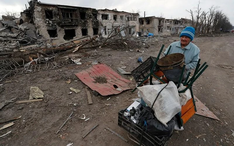 Người phụ nữ đẩy xe chở đồ đạc dọc theo một tuyến đường tại vùng Donetsk, Ukraine, ngày 15/3. (Ảnh: Reuters)