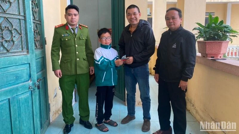 Em Nguyễn Bá Nhất, lớp 6A, Trường Tiểu học và Trung học cơ sở xã Quỳnh Minh, Quỳnh Phụ, tỉnh Thái Bình (thứ 2 từ trái qua) trao trả tài liệu cùng 19,5 triệu đồng nhặt được cho người bị đánh rơi.