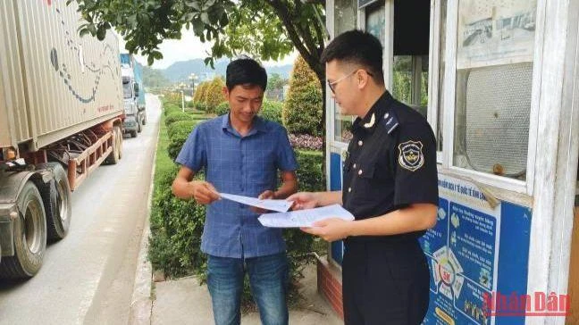 Cán bộ Chi cục Hải quan cửa khẩu quốc tế Hữu Nghị phát tờ rơi hướng dẫn Nền tảng cửa khẩu số cho lái xe tại cửa khẩu quốc tế Hữu Nghị. 