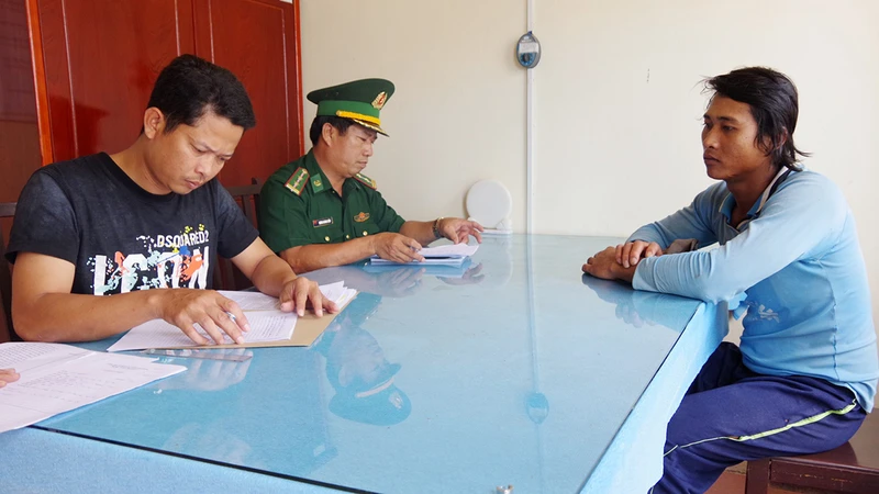 Đồn Biên phòng Trung Bình làm thủ tục bàn giao đối tượng Hữu Nghiêm (phải) cho Công an thị xã Giá Rai, tỉnh Bạc Liêu. 