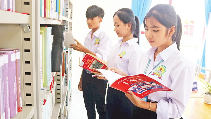 Học sinh Trường phổ thông dân tộc nội trú trung học cơ sở và phổ thông trung học huyện Tiểu Cần, tỉnh Trà Vinh đọc sách tại thư viện trường. (Ảnh MINH KHỞI) 