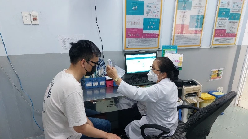 Bác sĩ khám sàng lọc trước tiêm. (Ảnh: Trung tâm Kiểm soát bệnh tật Thành phố Hồ Chí Minh)