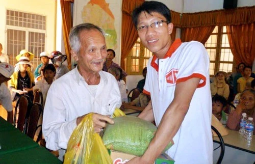 Anh Nguyễn Tiến Danh (bên phải) trao quà tặng người cao tuổi có hoàn cảnh khó khăn.