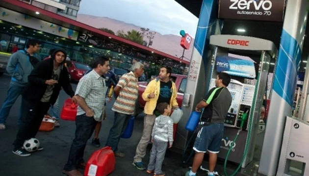 Người dân đợi mua nhiên liệu tại một trạm xăng ở thành phố Iquique, phía bắc Chile, ngày 2-4-2014. (Ảnh: Xinhua)