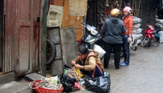 Người dân xóm đồng nát Hoàng Cầu (Hà Nội) phân loại phế liệu.