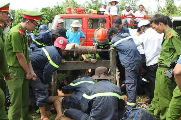 Lực lượng cứu hộ nỗ lực đưa thi thể các nạn nhân lên khỏi miệng giếng.
