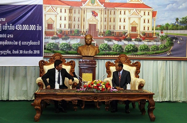 Bộ trưởng An ninh Lào Somkeo Silavong (phải) cảm ơn sự giúp đỡ quý báu mà Đảng, Nhà nước và nhân dân Việt Nam đã dành cho Lào, tại buổi trao tiền hỗ trợ, chiều tối 30-7.