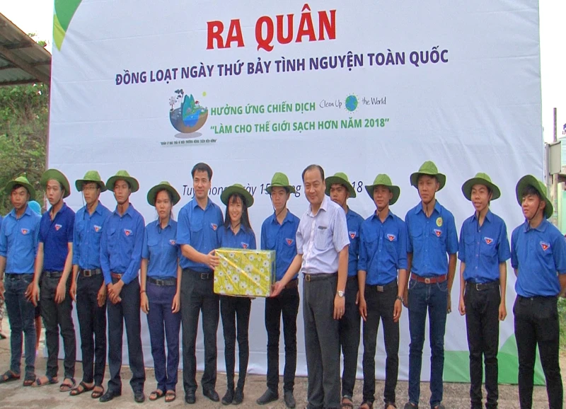 Đại diện Trung ương Đoàn TNCS Hồ Chí Minh trao tặng các vật dụng hỗ trợ thu gom, xử lý rác thải cho các đội tình nguyện ở địa phương.