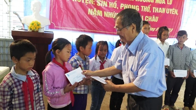 Đại diện Hội người Việt Nam tại Pháp trao học bổng cho học sinh nghèo vùng lũ huyện Phong Thổ.