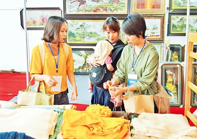 Khách nước ngoài tham quan, tìm hiểu các sản phẩm thủ công mỹ nghệ tại Hội chợ Hanoi Giftshow 2018.