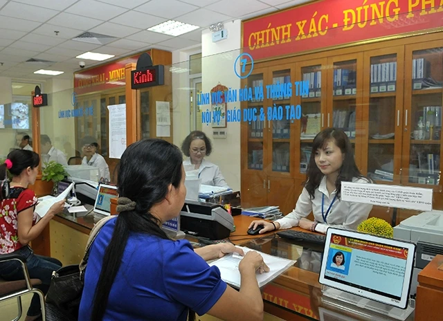 Tiếp nhận hồ sơ và giải quyết thủ tục hành chính cho người dân tại bộ phận một cửa UBND quận Hoàn Kiếm (Hà Nội). Ảnh: Nguyễn Đăng 