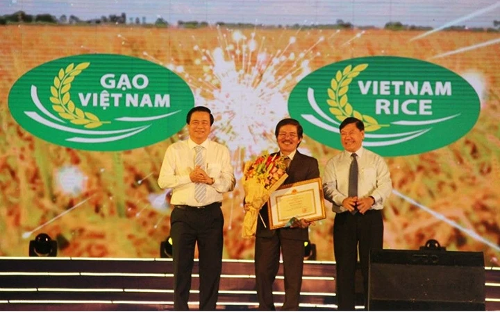 Đại diện Bộ Nông nghiệp và Phát triển nông thôn trao giải cho họa sĩ thiết kế logo thương hiệu Gạo Việt Nam. Ảnh: QUỲNH NHƯ