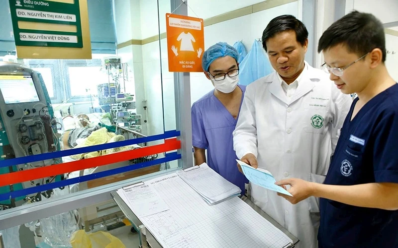 Các bác sĩ Khoa Hồi sức tích cực (Bệnh viện Bạch Mai) hội chẩn người bệnh mắc cúm mùa biến chứng nặng. Ảnh: DƯƠNG NGỌC