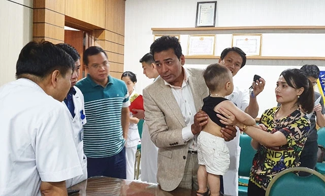 Giáo sư A. Ran-ga-na-than và các bác sĩ Khoa Chấn thương chỉnh hình (Bệnh viện Bạch Mai) thăm khám cho bệnh nhi bị cong vẹo cột sống.