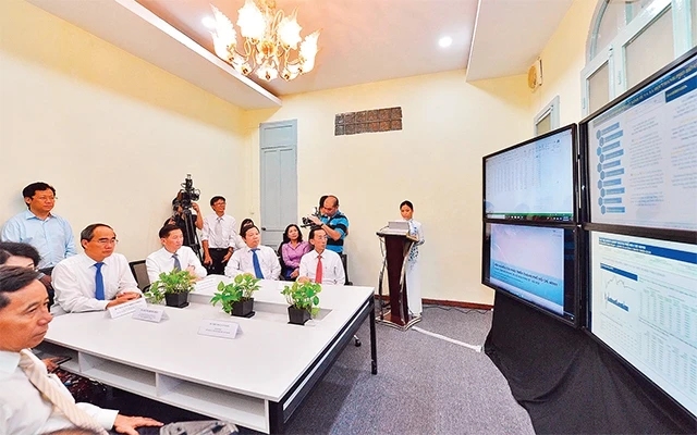 Bí thư Thành ủy TP Hồ Chí Minh Nguyễn Thiện Nhân xem các màn hình thể hiện số liệu tại Trung tâm Mô phỏng và dự báo kinh tế - xã hội TP Hồ Chí Minh.