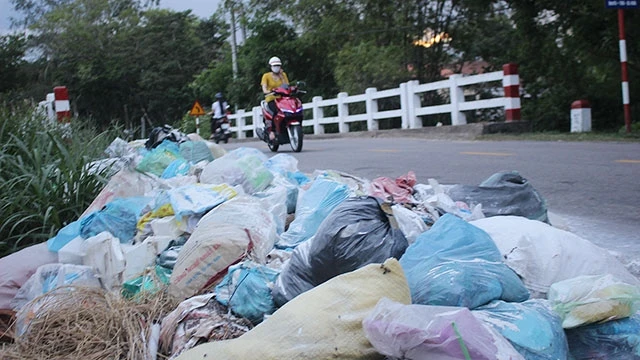 Rác thải đổ tràn ra quốc lộ 40B, đoạn qua xã Tam Thái, huyện Phú Ninh (Quảng Nam).