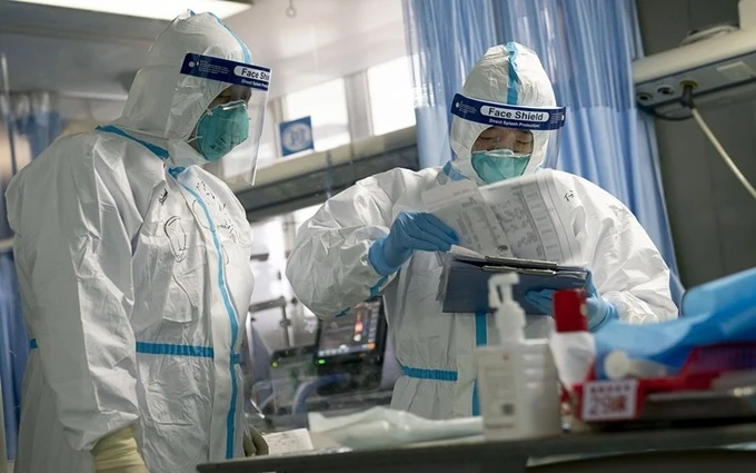 Nhân viên y tế đang kiểm tra hồ sơ chẩn đoán bệnh của một bệnh nhân tại Bệnh viện Trung Nam thuộc Đại học Vũ Hán, tỉnh Hồ Bắc, Trung Quốc, ngày 24-1. (Ảnh: Tân Hoa xã)