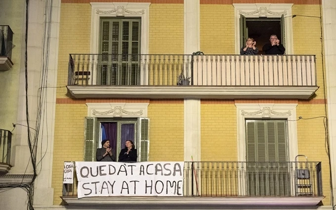 Người dân tại TP Barcelona, Tây Ban Nha, ra ban công vỗ tay cổ vũ tinh thần những nhân viên y tế đang gồng mình chống dịch. (Ảnh: Getty Image)